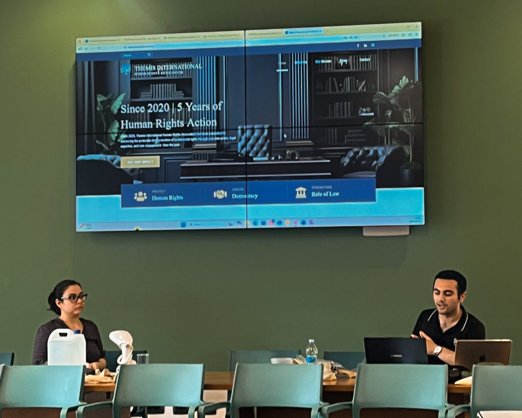 Vice-President Arayik Grigorian presenting the live legal-tech prototyping workshop with the Themis International screen in the background.